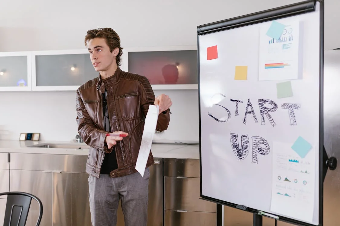 An entrepreneur presenting a startup pitch to potential investors in a co-working setting